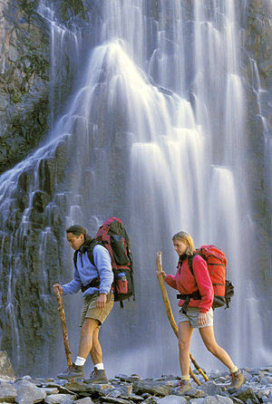 Couple hiking by waterfall